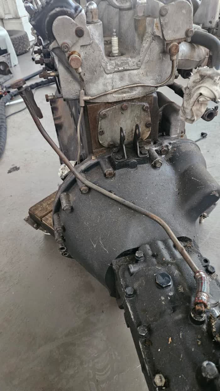 Grimy classic Jaguar engine and gearbox before dry ice cleaning